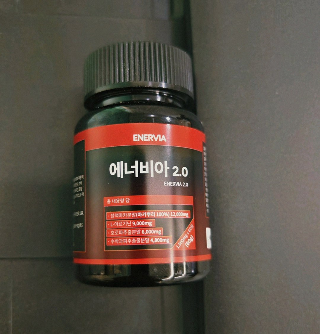 Korean Asian man in 30s taking supplement before gym after work