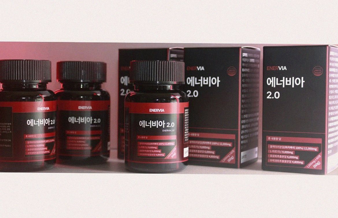 Korean Asian man 40s taking supplement with water morning routine