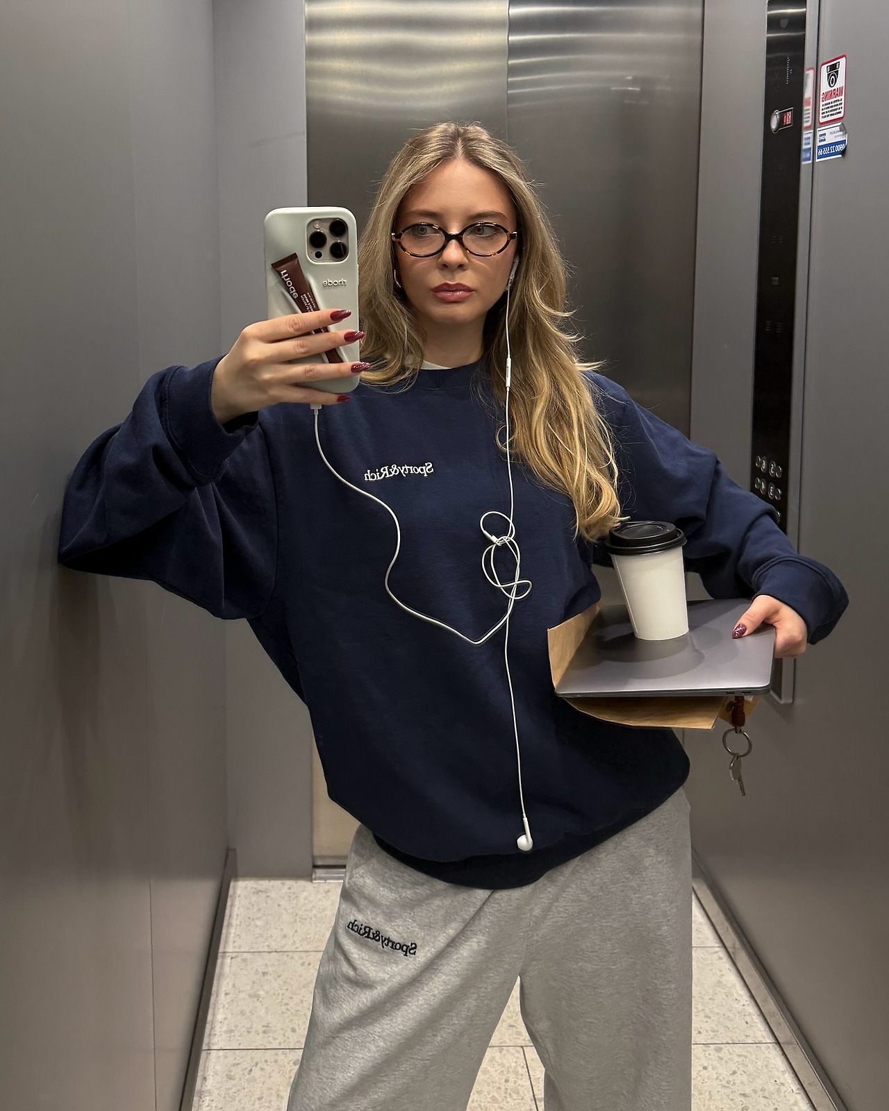 이어폰_엘리베이터 안에서 이어폰을 끼고 음악 듣는 여성