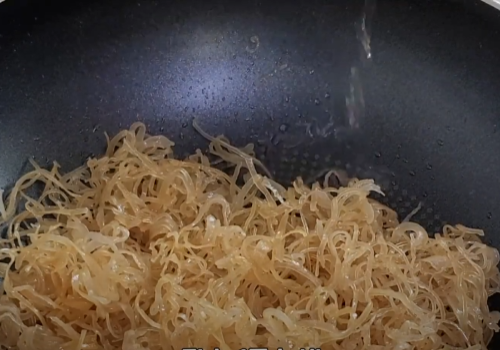 오징어채가 조금 꼬불꼬불해져 맛술 1큰술 반을 넣는 모습이예요