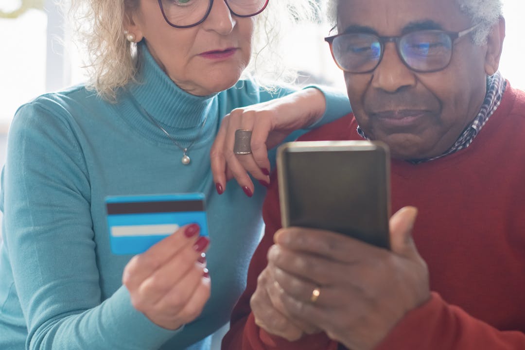 모바일로 환급 절차를 확인하는 중장년 부부의 모습, 디지털 온누리상품권 사용 시니어 참여 장면 연출