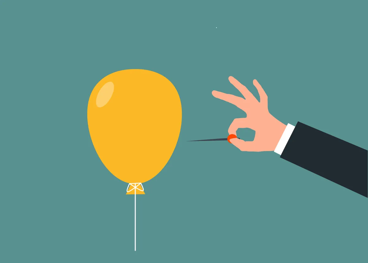 노란색-풍선을-바늘로-터뜨리려-하는-사람