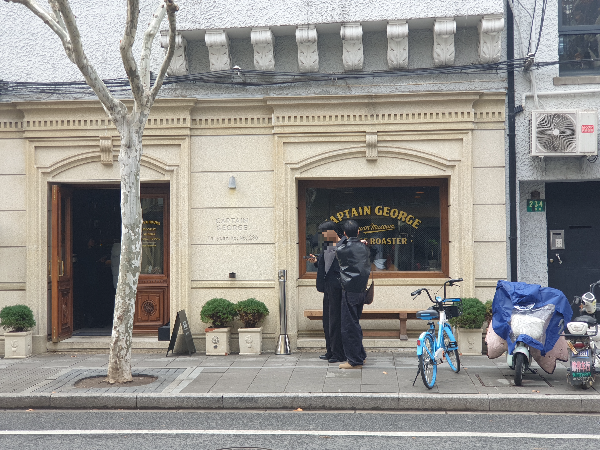 장식 몰딩과 아치형 프레임 창과 출입구를 가진 카페