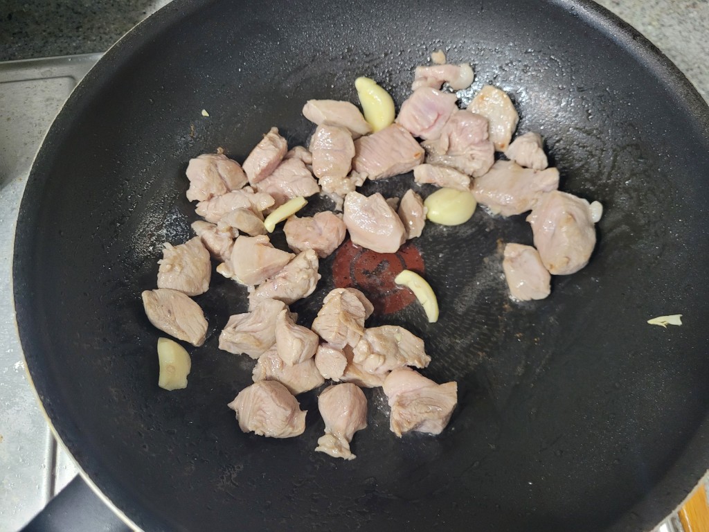 돼지고기에 마늘을 넣고 볶는 모습