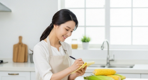 초당옥수수 보관법을 메모지에 적는 한국 주부의 모습