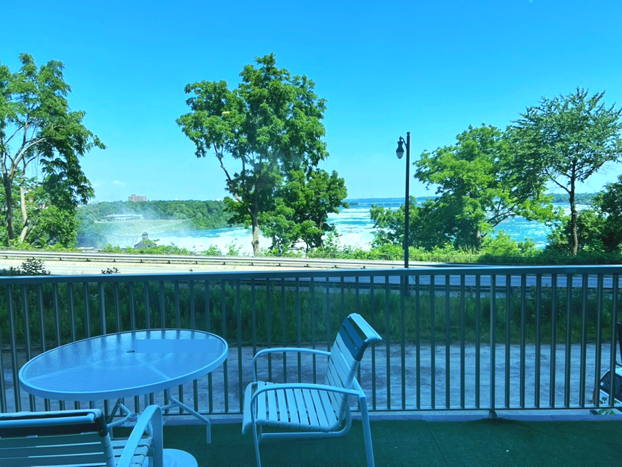 Outdoor terrace near the pool with partial Fallsview