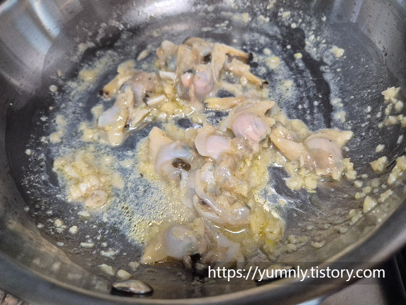 adding white wine in a pan