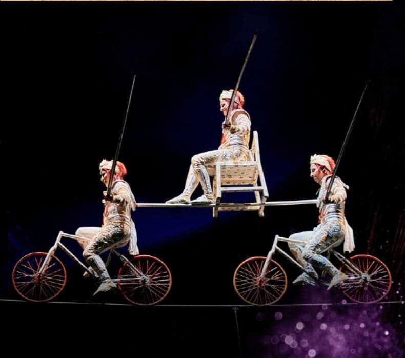 태양의 서커스 단원들의 외줄 자전거 타는 모습