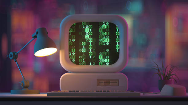 책상위에 미니어처 구형 컴퓨터가 탁상스탠드가 놓여있고 컴퓨터 모니터에 디지털코드가 나타나있다.