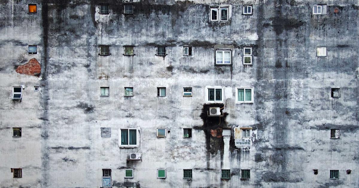 small business owner reviewing financial documents on a laptop, surrounded by cafe items
