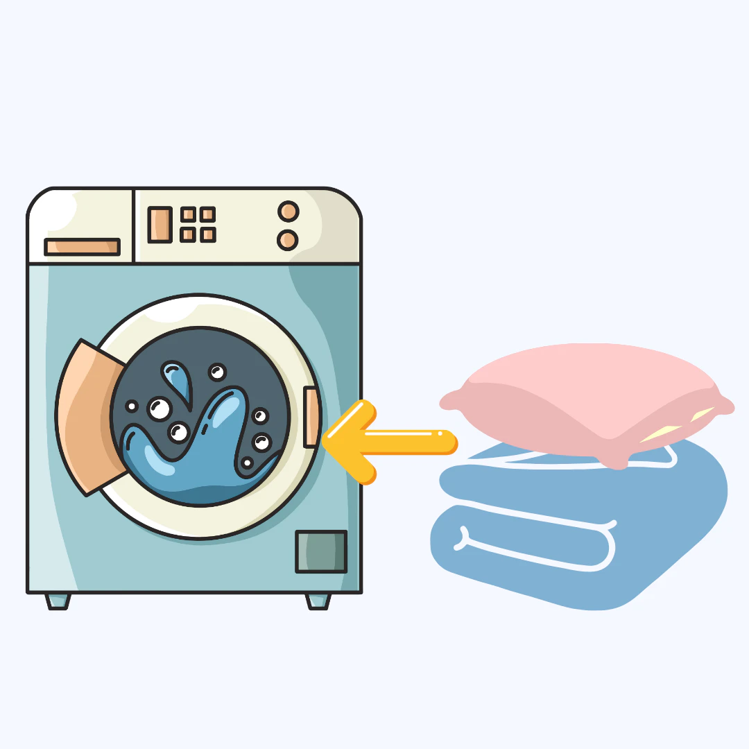 침대침구와 시트를 세탁기에 넣고있다