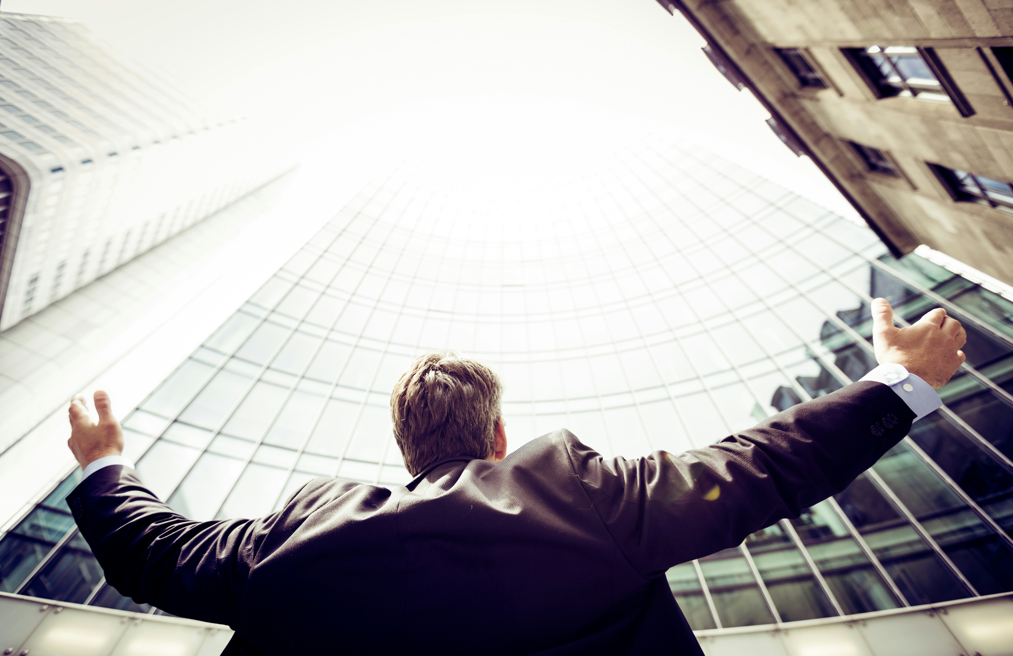 두팔 벌려 도시 빌딩에 서있는 남자 뒷모습