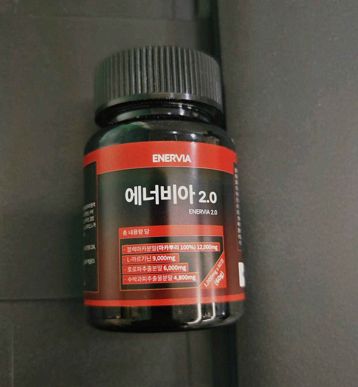 Korean Asian man in late 30s taking supplement with water in morning