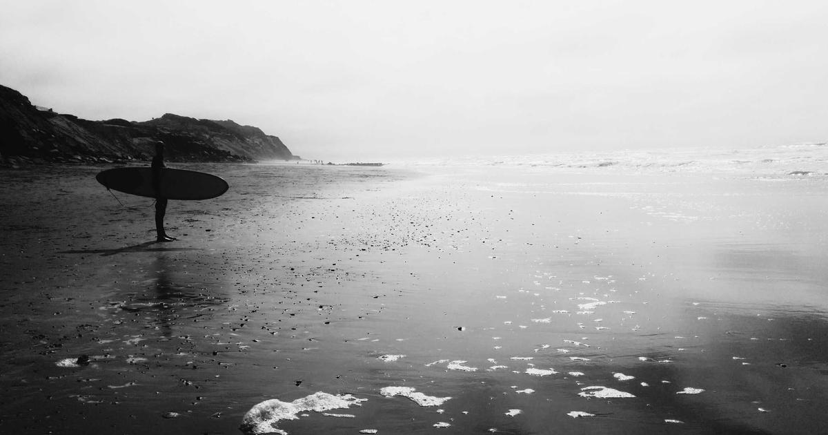 Young couple reviewing housing loan documents with a financial advisor, looking hopeful