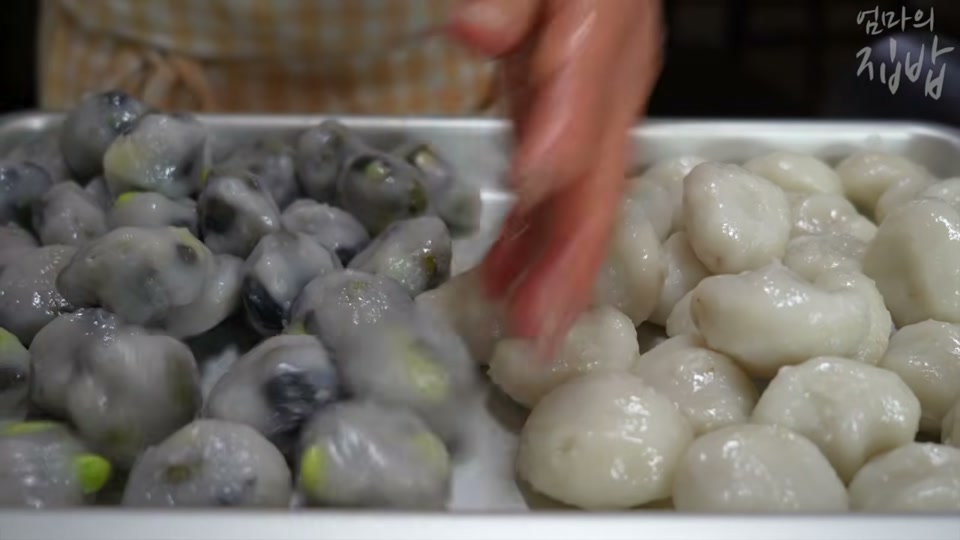 쟁반에 나란히 담은 콩송편과 깨송편
