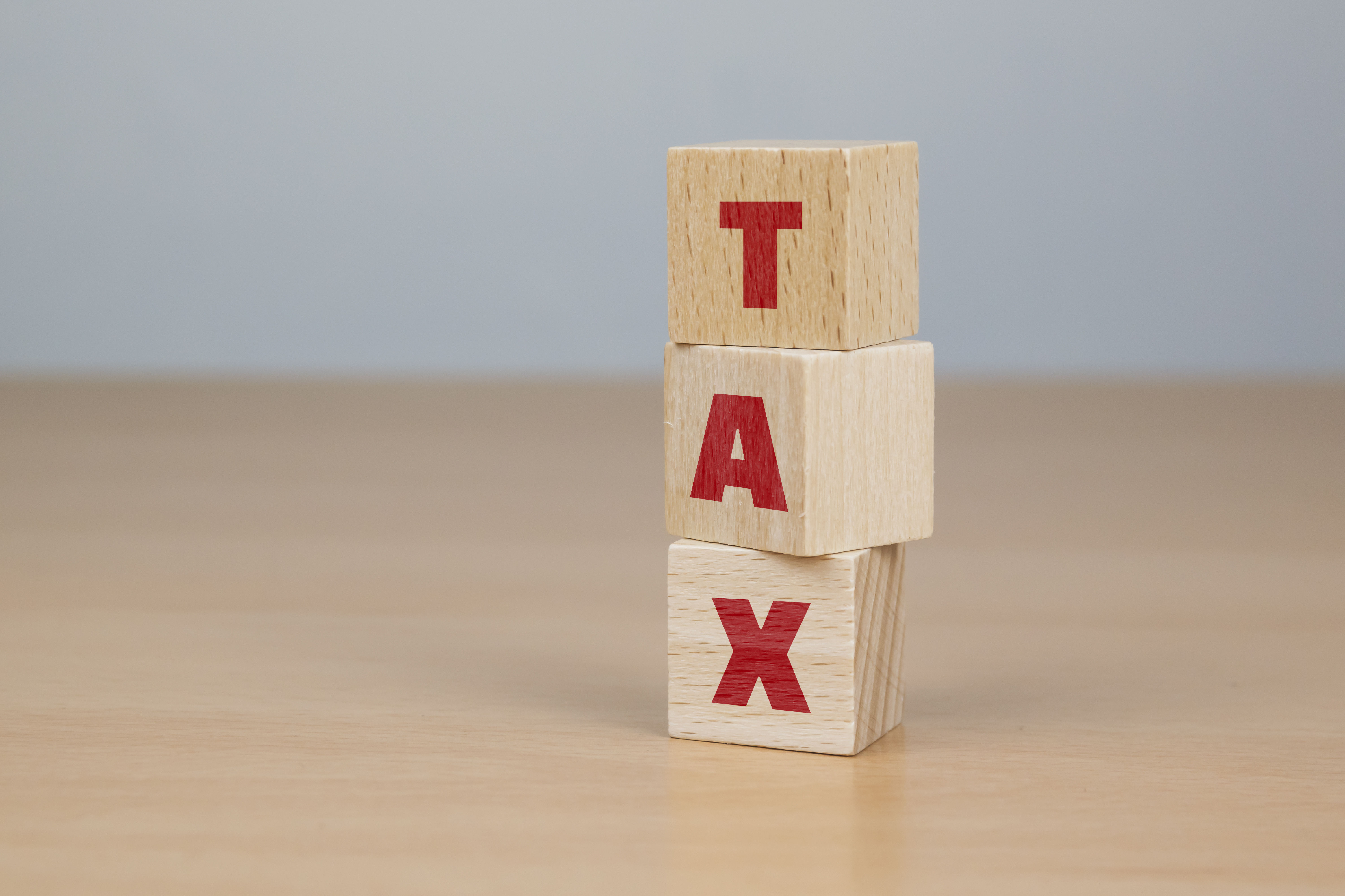 세금 납부와 절세를 상징하는 TAX 알파벳 나무 블록 쌓기 이미지