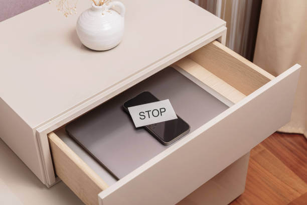 디지털 디톡스를 위해 stop이라고 쓴 메모를 휴대전화 위에 올려 서랍에 넣어 둔 사진