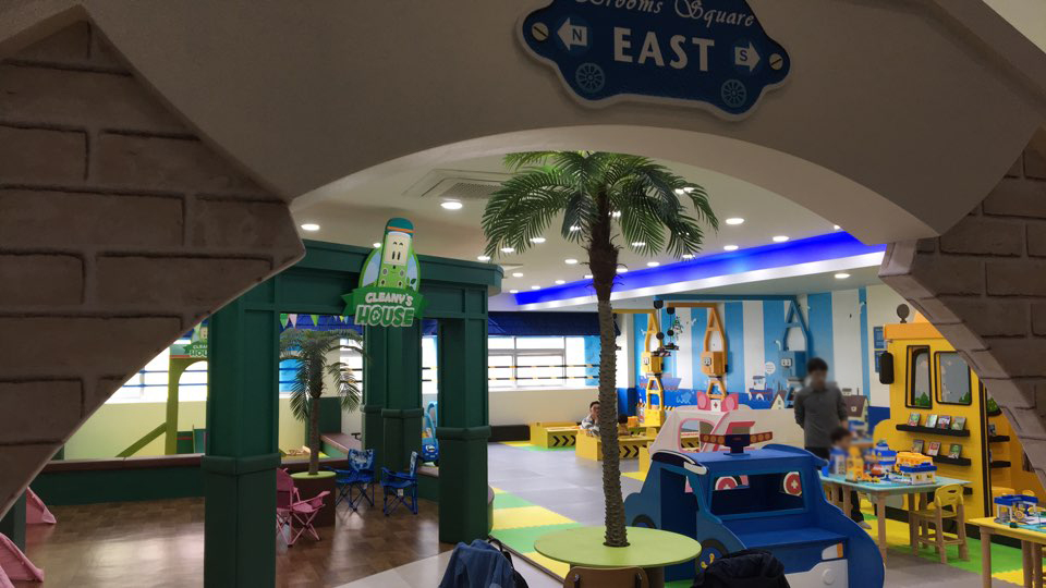 로보카폴리 키즈카페 EAST 존 전경, 야자수 데코와 놀이테이블&middot;미끄럼 매트가 있는 밝은 실내 놀이터
