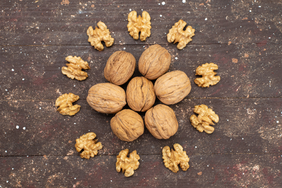 top-view-fresh-whole-walnuts-inside-shell-cleaned-out-lined-brown