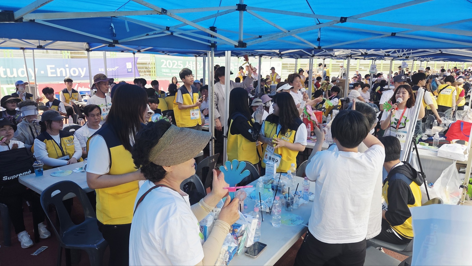 동작지회 부스에 앉아있고 응원을 함께하는 지회원과 직원들, 봉사자의 모습