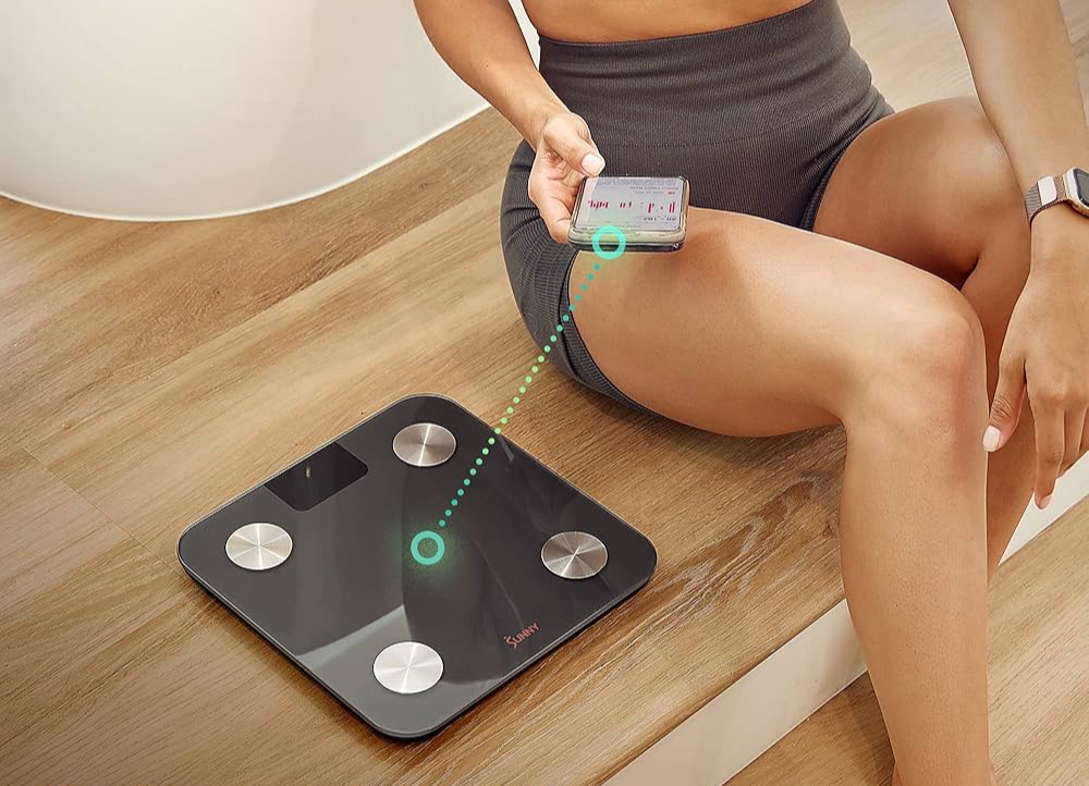 Middle-aged men and women using smart scales and health management, weight measurement devices to record weight