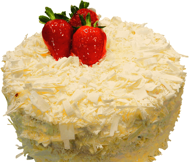 하얀 초콜릿 조각이 가득한 동그란 생일케이크 위에 빨간 딸기 세 개가 올려져 있다.