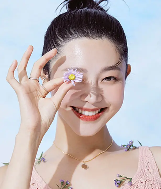 솔로지옥 3- 머리 전체를 위로 올려묶고 금색 펜던트를 단 목걸이를 한채 분홍색 나시티를 입고 오른손가락 엄지와 검지로 민들레 꽃을 오른쪽 눈앞에 대고 환화게 웃고있는 최혜선