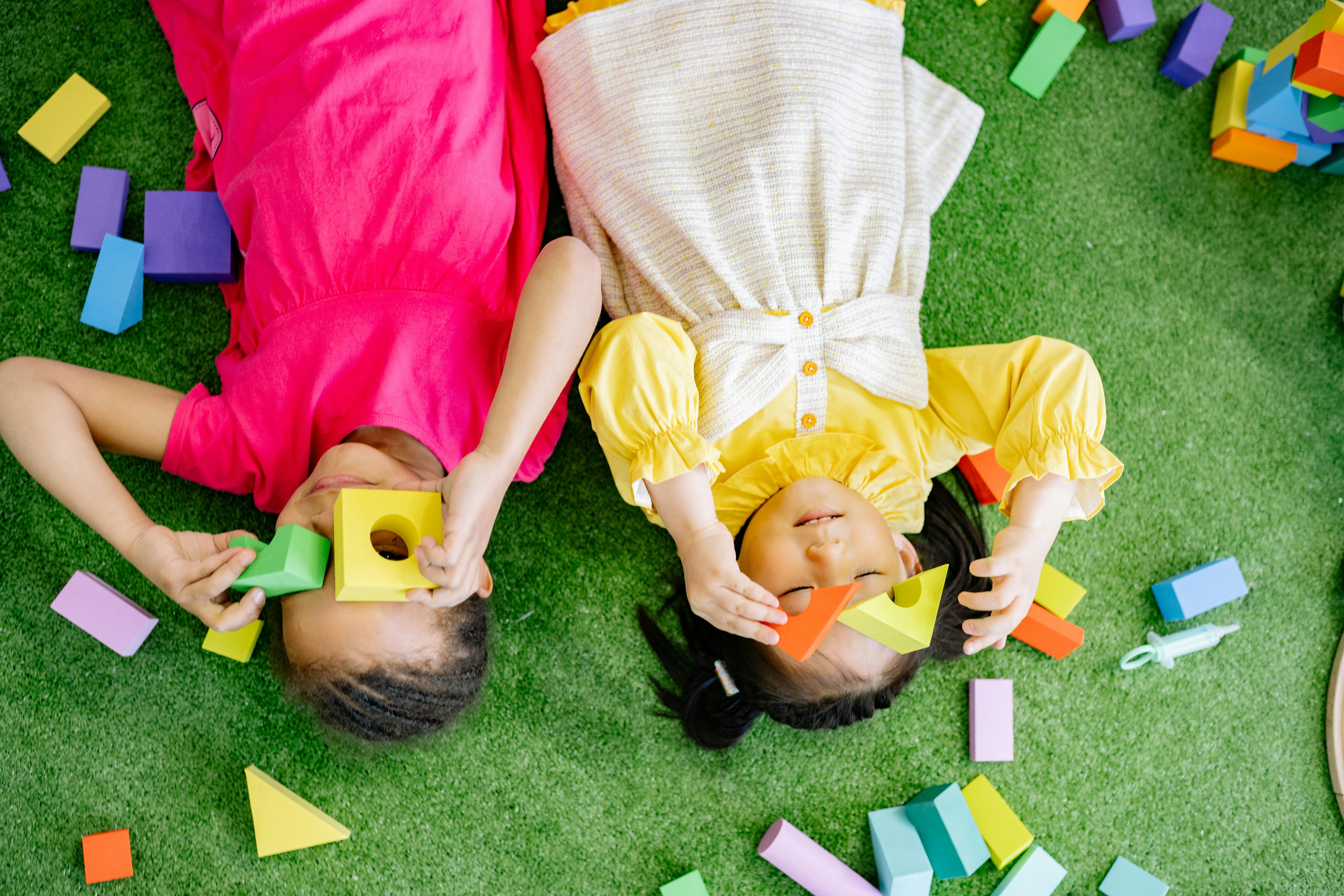 two little girls playing with blocks