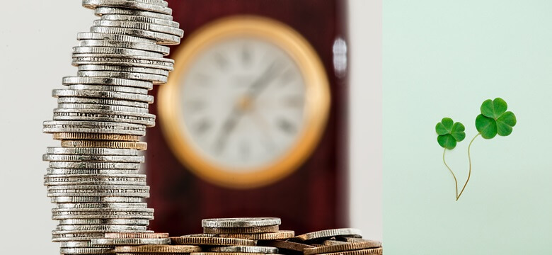 좌측은 뒤쪽에 원형의 벽시계를 배경으로 동전 수십개를 높이 쌓아두고 그 옆 바닥 수평방향으로 여러개의 동전이 깔려있는 사진이며, 우측은 네잎클로버 2개가 있는 사진