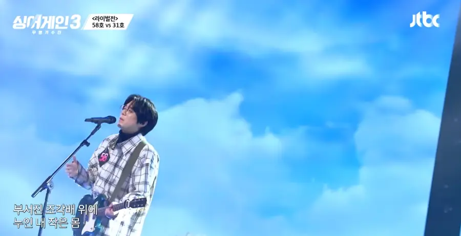 싱어게인3-
체크무늬 셔츠에 검정색 폴로티를 입고 초록색 전기기타를 치며 스탠딩마이크 앞에서 눈을 감고 노래하는 58호