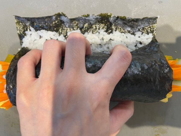 Rolling kimbap tightly with your hands