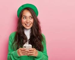 Cheerful Korean woman showing Instagram on her phone