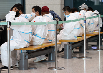 방역복을 입고있는 해외입국자들 모습