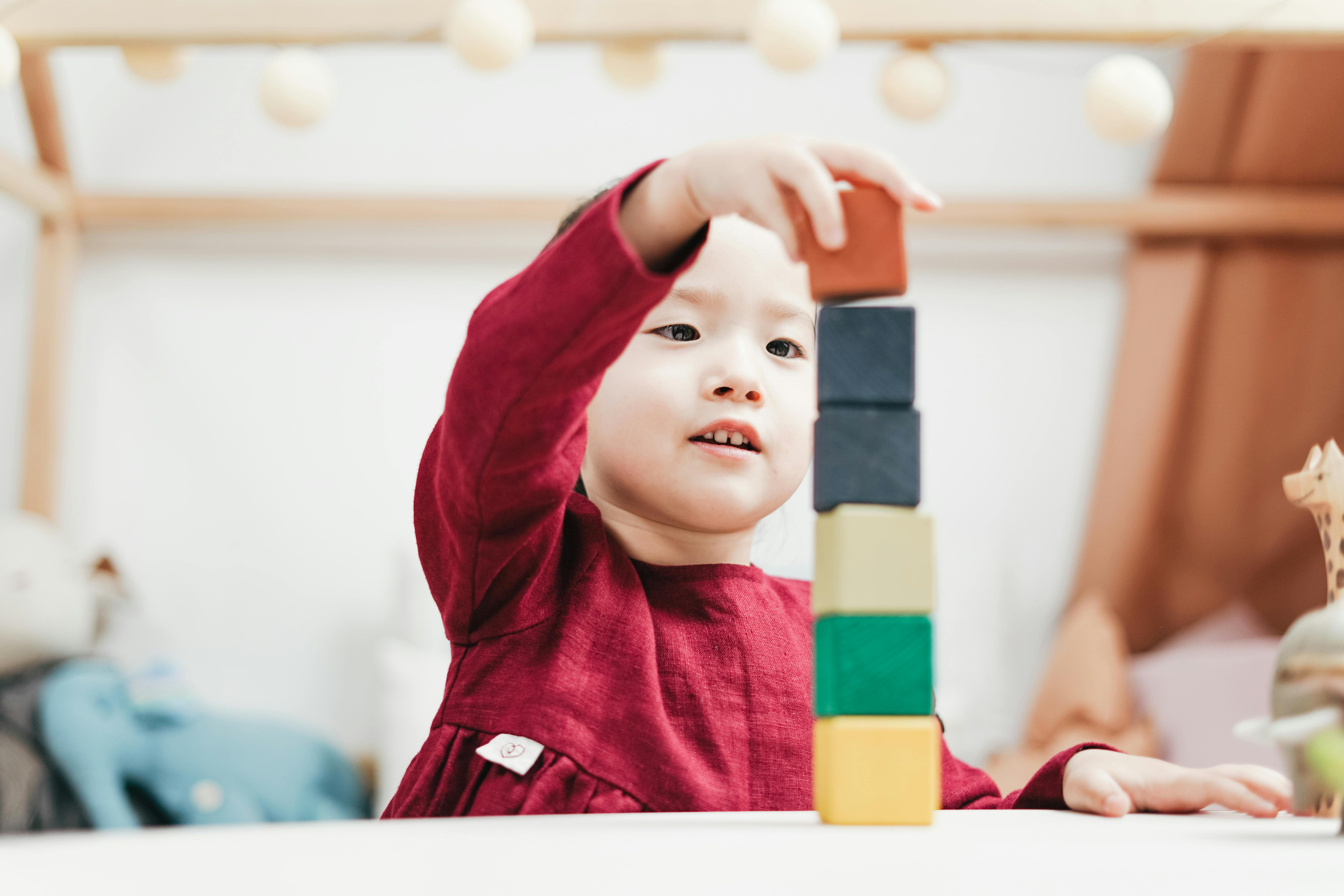 little boy playing with wood blocks