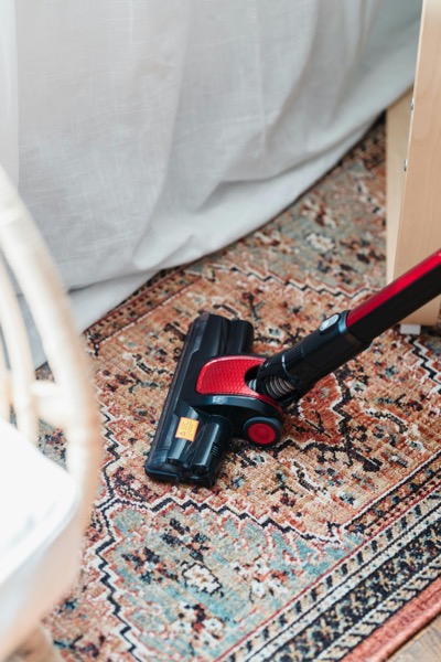 원룸 바닥을 청소하는 무선청소기 사용 장면