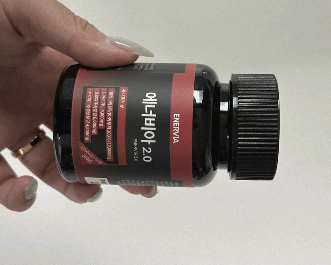 enervia 2.0 supplement bottle on desk with water glass