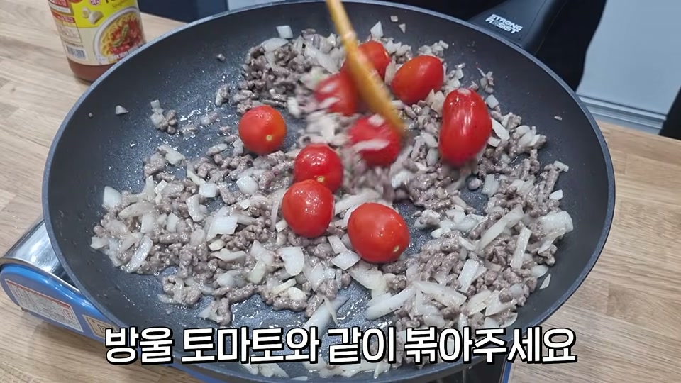 방울토마토를 더해 볶는 장면