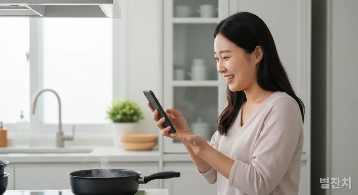 집에서 요리하며 업무 알림을 확인하는 한국인 여성의 워라블 일상