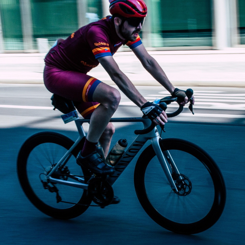 Close-up of cyclist legs and feet demonstrating proper pedaling technique on road bike