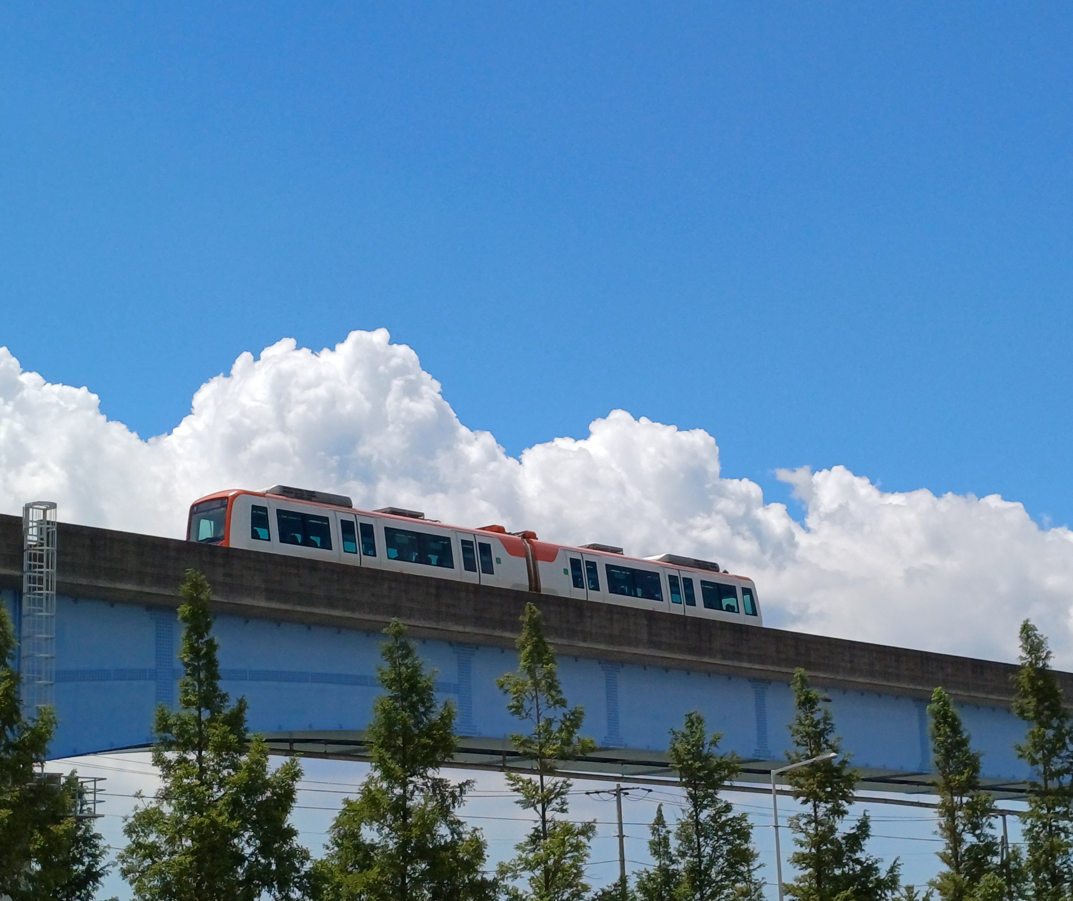 light rail passing beneath cotton candy&ndash;like clouds