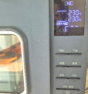 A domestic convection oven being preheated with an internal oven thermometer for sourdough baking.