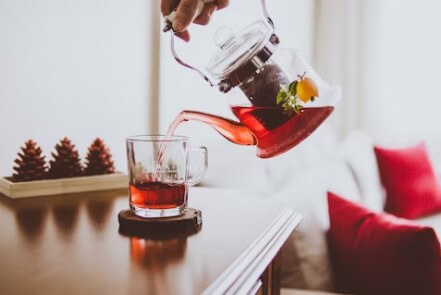 주전자에서 오미자 차가 컵에 따라지는 장면