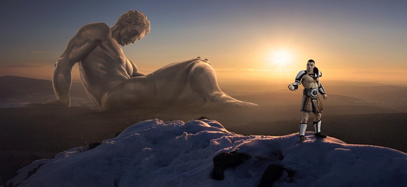 거인은 앉아있고 일반사람은 산에 서 있는 이미지