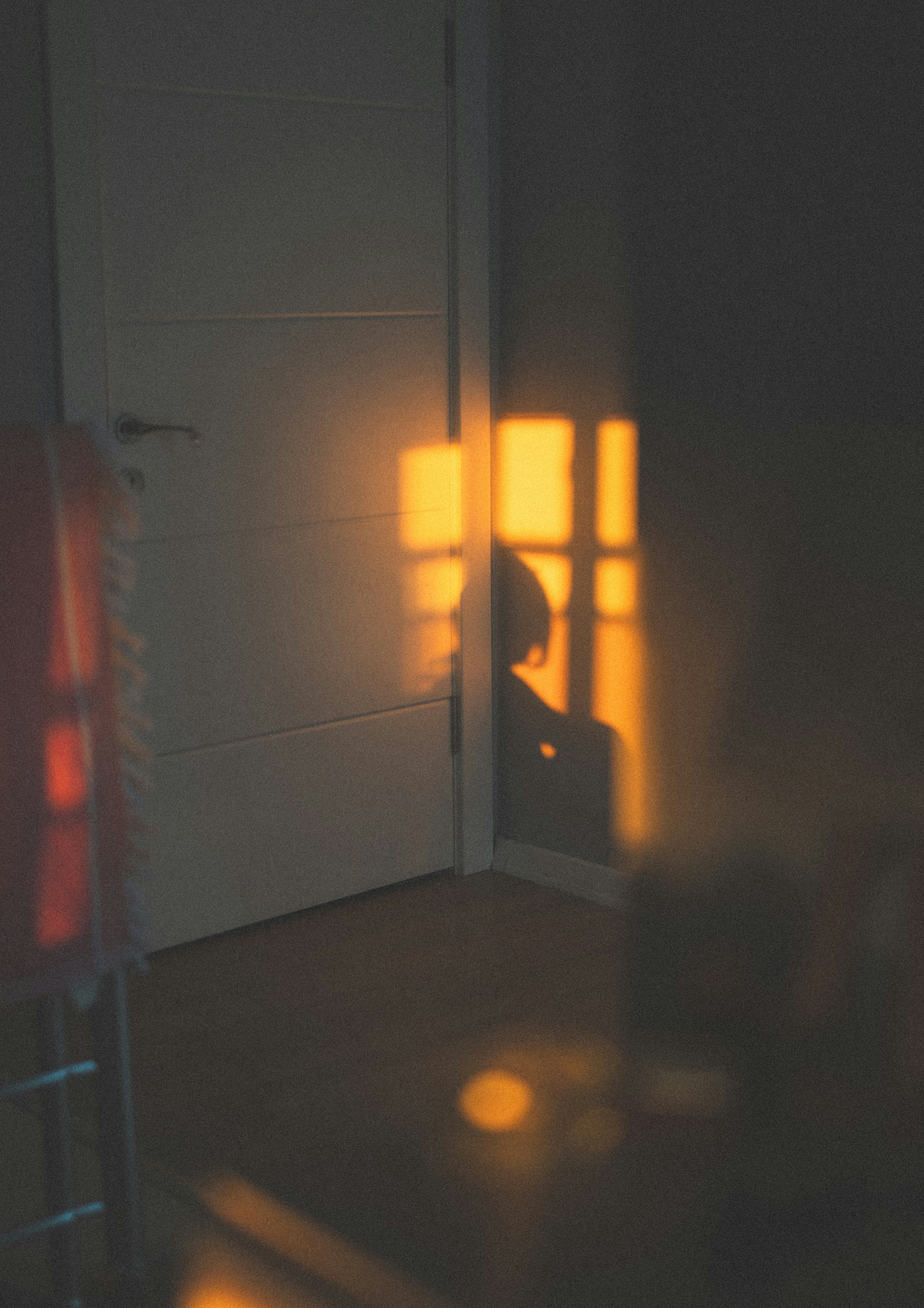 어두운 겨울 저녁, 작은 스탠드 조명 아래 혼자 앉아 있는 차분한 실내 분위기 관련 사진