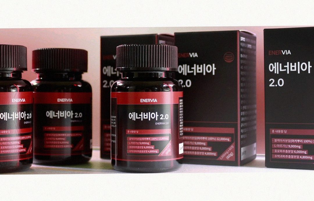 Korean Asian man in 40s taking supplement with water in morning