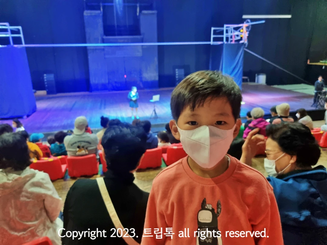 공연 시작전 무대를 배경으로 서 있는 아이