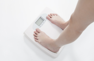 체중계에 몸무게를 재고있는 사람