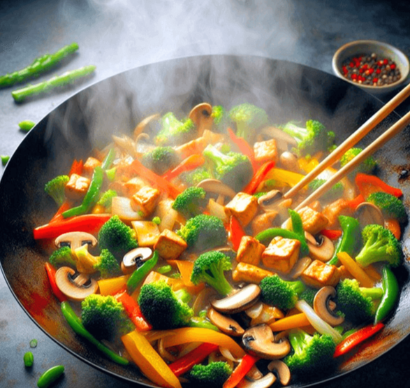 커다란 둥근 프라이팬에 작게 썬 두부와 브로콜리, 붉은 파프리카, 양송이버섯이 볶아지고 있다. 기다란 나무젓가락으로 재료를 섞는다.