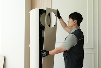 에어컨을 분해해 내부 상태를 확인하는 남성