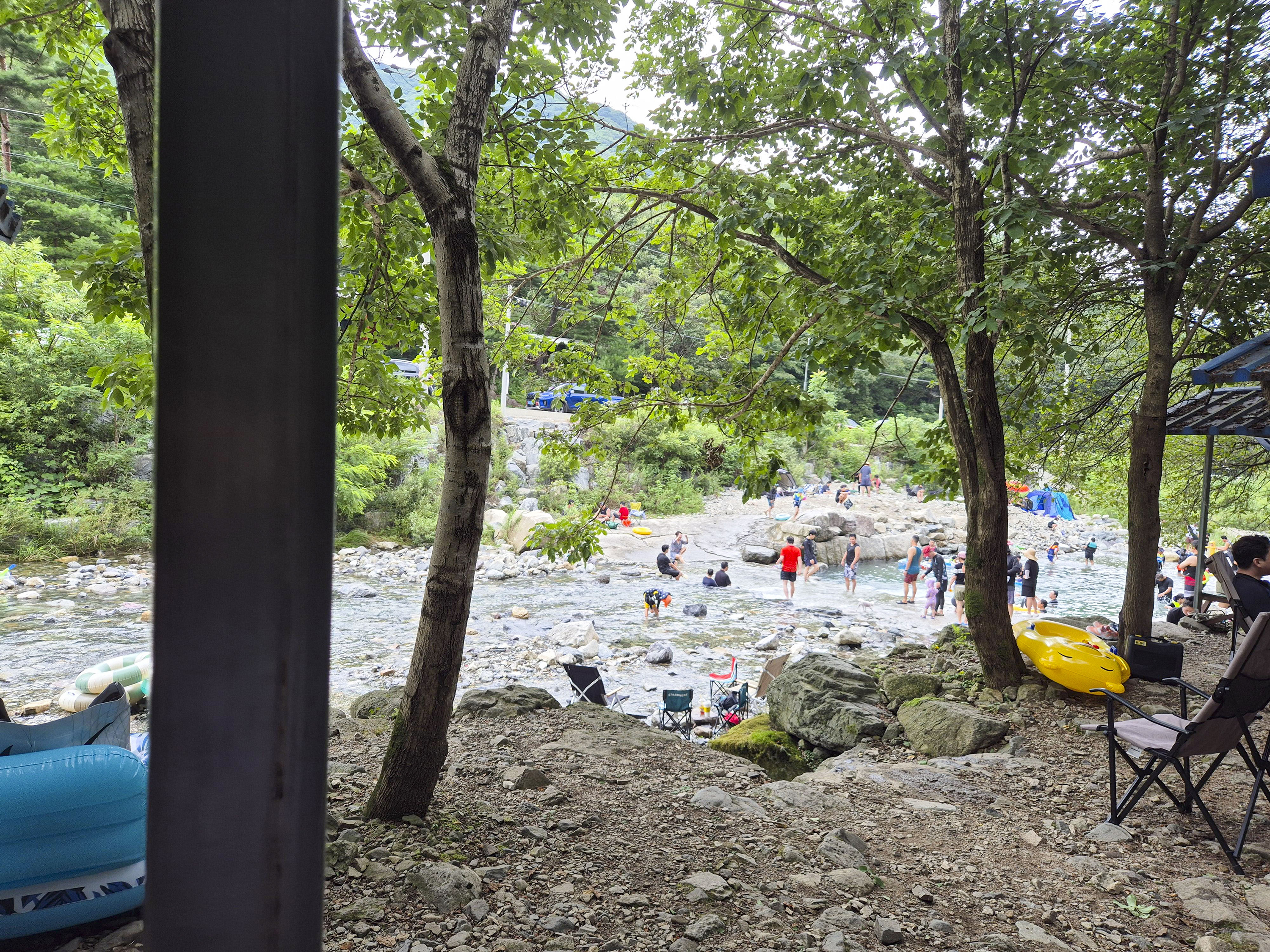 계곡에 들어가서 물놀이 하는 사람들